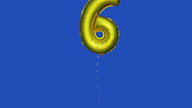 foil balloon with number 6 moving across blue screen