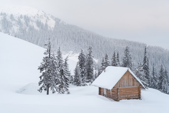 Snowy Winter Mountain Landscape With Wooden Cabin
