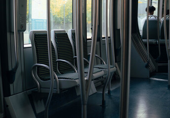 Empty tram seats, blue-grey style with dark textile seats with yellow polka dots.