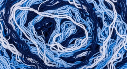 Twisted, swirling, messy pile of blue and white yarn, background pattern