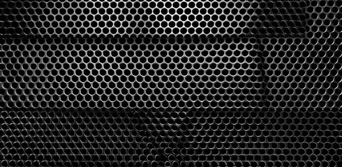 Metal grille with circular holes, dark, shiny, and industrial looking material