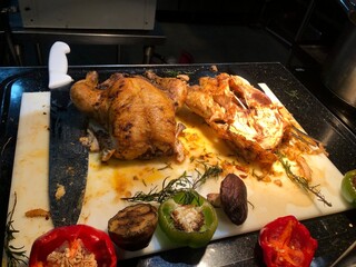 Roasted chicken on a cutting board with vegetables