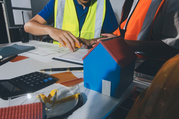 Closeup of team of industrial engineers meeting analyze machinery blueprints consult project on...