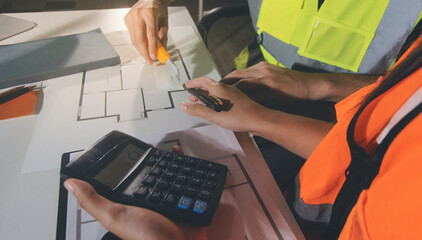 Closeup of team of industrial engineers meeting analyze machinery blueprints consult project on...