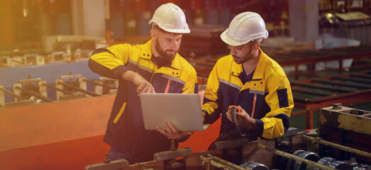 Technician maintains and inspects metal sheets in a metal cheese plant with computers and radio...