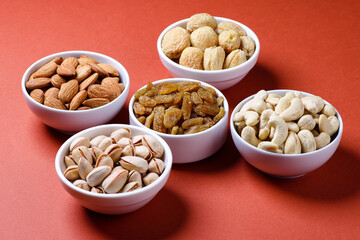 Indian dry fruits called almonds, apricot, cashews,  pistachio, raisins isolated on dark background 