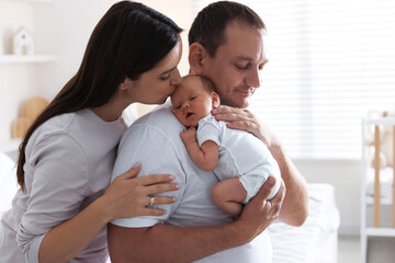 Mother and father with their newborn baby at home