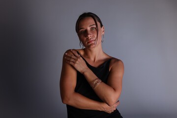 Portrait of beautiful woman with bracelet on grey background