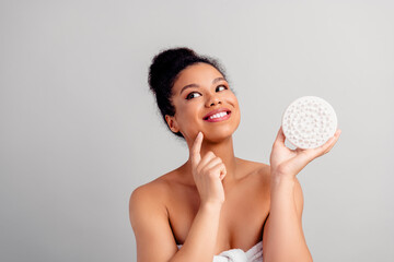 Young woman with glowing skin holding a beauty tool, demonstrating self-care and skincare routine