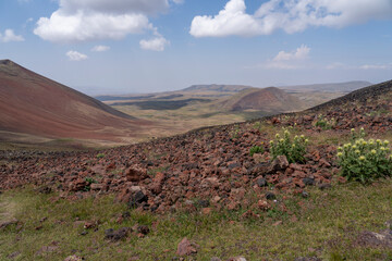 Scenic Volcanic Hills with Red Earth and Vegetation