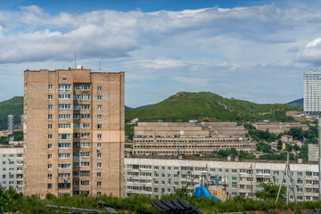 Fototapeta premium Vladivostok landscape: Soviet buildings and unique old automobile garages on a rugged hill, or sopka, in Primorsky Krai urban expanse. 