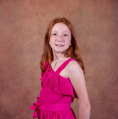 photo shoot in the studio, for red-haired siblings on the day of their communion. Ochre background.
