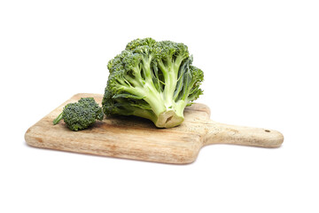 Fresh green broccoli on a wooden cutting board, showcasing vibrant color and texture, ideal for...