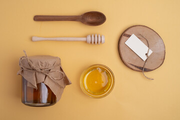 Honey mockup for branding. Honey jar with wooden spoon. Tasty honey bin.