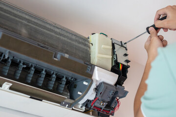 Electrician man repair and maintenance air conditioner