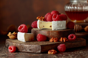 Camembert cheese with fresh raspberries and walnuts.