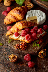 Croissant with camembert cheese, raspberries and walnuts.