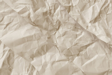 Obraz premium Crumpled light brown paper suitable for backgrounds, textures, creative designs, and artistic projects in need of a distressed surface.