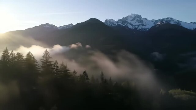 Misty mountain range with cloud inversion at sunrise nature scene