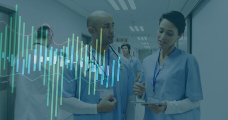 Reviewing adult female and male medical staff consulting tablet data in hospital corridor, teamwork