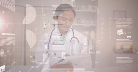 Reviewing digital charts female doctor using tablet in clinic, with stethoscope and medicine