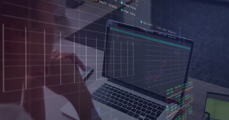 Studying financial charts on laptop, mid adult woman holding eyeglasses on wooden desk, copy space