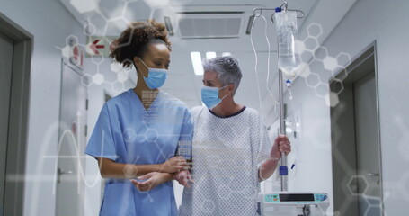 Walking nurse assisting senior masked patient in hospital corridor with IV pole, hexagon graphics