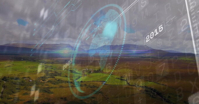 Displaying transparent circular interface hovering over rural farmland, with globe map and 2015 tag