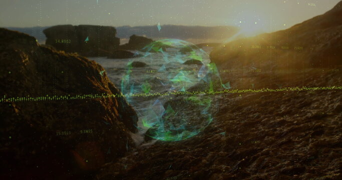 Spinning holographic 3D globe hovering above rocky shoreline at sunrise, with numeric data points