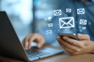 Person using laptop and phone, email icons