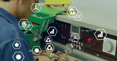 Assembling technician testing circuit board at bench, with green toolbox and AR icons, copy space