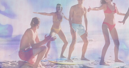 Group of six beachgoers practicing balance on surfboards on sandy beach, with bright swimwear