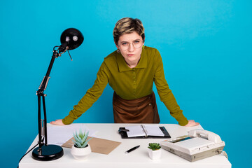 Professional woman in retro style attire at her desk, surrounded by office supplies, with a...