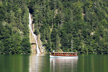 The waterfall at Königssee with tourist boat