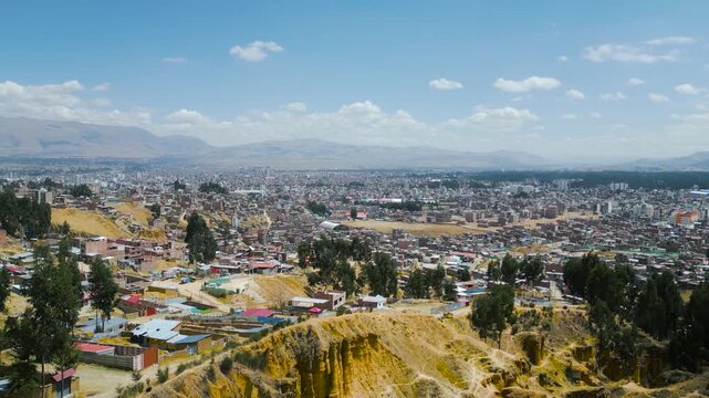Aerial drone panorama of Huancayo city under clear blue sky on a sunny day.