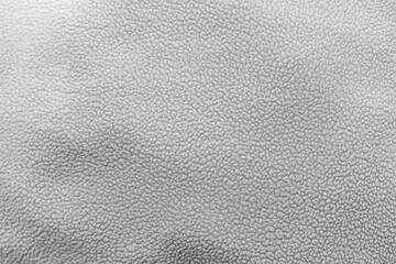 Textured surface of gray leather material with subtle patterns and variations