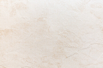 Light beige textured surface with subtle patterns for backgrounds or surfaces