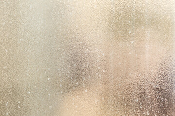 Frosted glass texture with abstract blurred background in soft colors