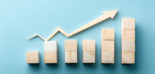 Wooden blocks chart with an upward arrow on a blue background, symbolizing growth