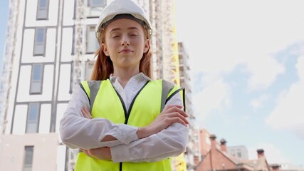 Confident construction professional oversees project progress at urban building site during a sunny day