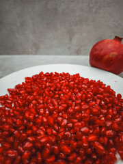 Plate of pomegranate seeds symbolizing rosh hashanah, love, and rebirth