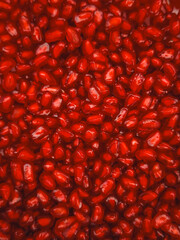 Juicy pomegranate seeds creating vibrant red background for rosh hashanah