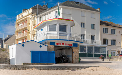Langrune-Sur-Mer, France - 08 07 2025: Detail view of the lifeguard station, buildings and blue sky behind