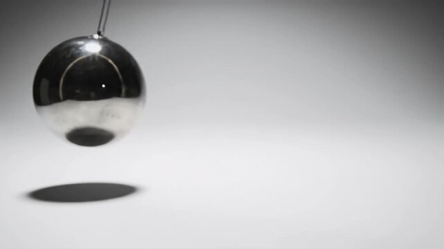 Swinging metallic egg pendulum motion physics experiment