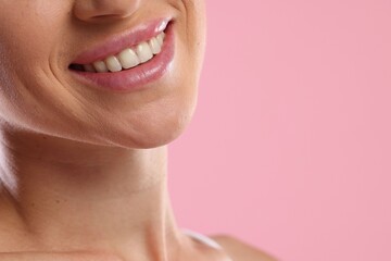 Fototapeta premium Woman with beautiful healthy teeth on pink background, closeup. Space for text