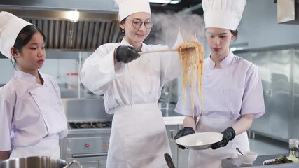 Chef instructor teaching students in kitchen class