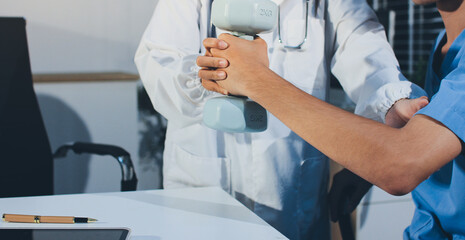 Person using hand weight with support of nurse