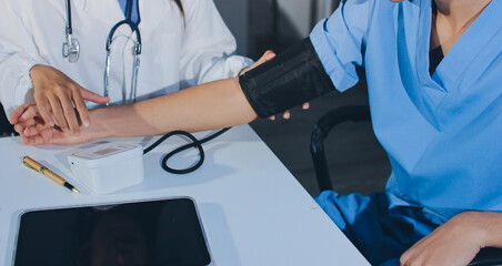 Doctor checking patient arterial blood pressure in hospital. Health care Concept