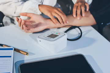 Doctor checking patient arterial blood pressure in hospital. Health care Concept