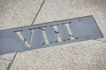 Fototapeta premium Roman numerical number eight made of stone tiles on street